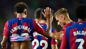 Barcelona's Spanish forward #27 Lamine Yamal and Barcelona's Spanish midfielder #32 Fermin Lopez celebrate Sevilla's Spanish defender #04 Sergio Ramos' owngoal during the Spanish Liga football match between FC Barcelona and Sevilla FC at the Estadi Olimpic Lluis Companys in Barcelona on September 29, 2023. (Photo by Pau BARRENA / AFP)