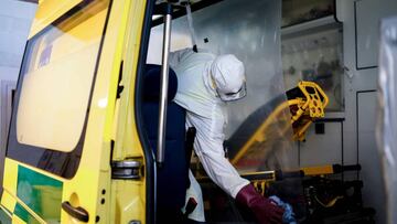 A Belgian fireman disinfects an ambulance. 
