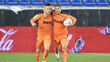 VITORIA-GASTEIZ, SPAIN - NOVEMBER 22: Manu Vallejo of Valencia (R) celebrates with teammate Kevin Gameiro of Valencia (L) after scoring their sides first goal during the La Liga Santander match between Alaves and Valencia on November 22, 2020 in Vitoria-G