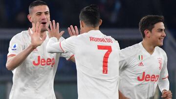Juventus' Turkish defender Merih Demiral (L) celebrates with Juventus' Portuguese forward Cristiano Ronaldo (C) and Juventus' Argentine forward Paulo Dybala after opening the scoring during the Italian Serie A football match AS Roma vs Juve