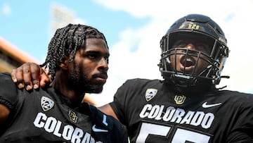 Center Van Wells #55 and quarterback Shedeur Sanders #2 of the Colorado Buffaloes