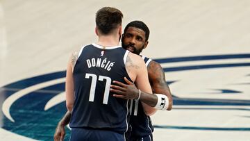 DALLAS, TEXAS - MAY 26: Luka Doncic #77 and Kyrie Irving #11 of the Dallas Mavericks embrace during the fourth quarter against the Minnesota Timberwolves in Game Three of the Western Conference Finals at American Airlines Center on May 26, 2024 in Dallas, Texas. NOTE TO USER: User expressly acknowledges and agrees that, by downloading and or using this photograph, User is consenting to the terms and conditions of the Getty Images License Agreement.   Cooper Neill/Getty Images/AFP (Photo by Cooper Neill / GETTY IMAGES NORTH AMERICA / Getty Images via AFP)