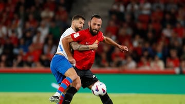 Real Mallorca's Kosovar forward #07 Vedat Muriqi (R) fights for the ball with Barcelona's Spanish defender #05 Inigo Martinez during the Spanish Liga football match between RCD Mallorca and FC Barcelona at the Mallorca Son Moix stadium in Palma de Mallorca on September 26, 2023. (Photo by JAIME REINA / AFP)