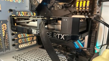 Close-up of an Nvidia GeForce RTX 4060 seated in a custom PC build, illuminated by RGB lighting.