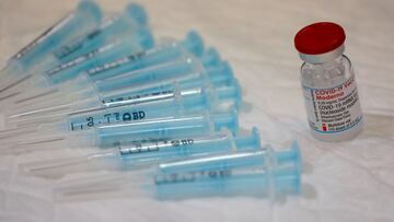 A vial containing doses of the Moderna vaccine against the coronavirus disease (COVID-19) and empty syringes are seen at a vaccination centre in Ronda, Spain June 9, 2021. REUTERS/Jon Nazca