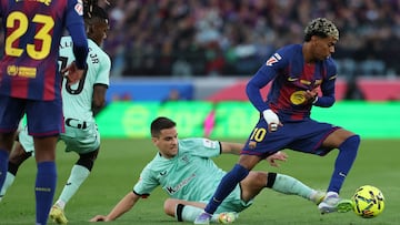 Athletic Bilbao's Spanish midfielder #16 Inigo Ruiz de Galarreta tackles Barcelona's Spanish forward #10 Lamine Yamal during the Spanish league football match between FC Barcelona and Athletic Club Bilbao at Camp Nou Stadium in Barcelona on November 22, 2025. (Photo by Lluis GENE / AFP)