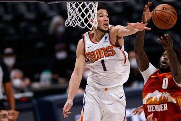 Phoenix Suns guard Devin Booker (1) battles for a rebound with Denver Nuggets forward JaMychal Green (0) in the first quarter during game four in the second round of the 2021 NBA Playoffs at Ball Arena.
