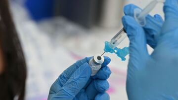 A healthcare worker fills a syringe with Pfizer Covid-19 vaccine at a community vaccination event in a predominately Latino neighborhood in Los Angeles, California, August 11, 2021. - All teachers in California will have to be vaccinated against Covid-19 or submit to weekly virus tests, Governor Gavin Newsom announced on August 11, as authorities grapple with exploding infection rates. The number of people testing positive for the disease has surged in recent weeks, with the highly infectious Delta variant blamed for the bulk of new cases. (Photo by Robyn Beck / AFP)