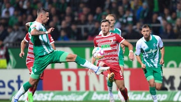 dpatop - 09 September 2022, Bremen: Soccer: Bundesliga, Werder Bremen - FC Augsburg, Matchday 6, wohninvest Weserstadion. Werder's Marco Friedl (l) fights Augsburg's Ermedin Demirovic for the ball. Photo: Carmen Jaspersen/dpa - IMPORTANT NOTE: In accordance with the requirements of the DFL Deutsche Fußball Liga and the DFB Deutscher Fußball-Bund, it is prohibited to use or have used photographs taken in the stadium and/or of the match in the form of sequence pictures and/or video-like photo series. (Photo by Carmen Jaspersen/picture alliance via Getty Images)