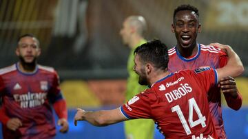 Lyon's Zimbabwean forward Tino Kadewere (R) is congratulated by Lyon's French defender Leo Dubois after scoring a goal during the French L1 football match between Angers SCO and Olympique Lyonnais, at the Raymond-Kopa Stadium, in Angers, western