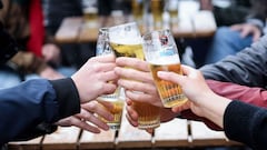 Friends toast each other as they drink a beer on a terrace in Brussels, on May 8, 2021, as the Belgium government eased the restrictions put in place to curb the spread of the coronavirus Covid-19. (Photo by Kenzo TRIBOUILLARD / AFP)