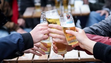 Friends toast each other as they drink a beer on a terrace in Brussels, on May 8, 2021, as the Belgium government eased the restrictions put in place to curb the spread of the coronavirus Covid-19. (Photo by Kenzo TRIBOUILLARD / AFP)