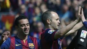 Iniesta y, detrás, Xavi.