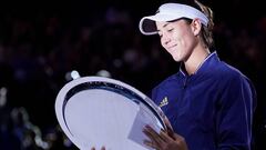 Garbine Muguruza of Spain is presented with the runner up plate following her women's singles final against Sofia Kenin of the USA on day 13 of the Australian Open tennis tournament at Rod Laver Arena in Melbourne, Saturday, February 1, 2020. (AAP Image/M