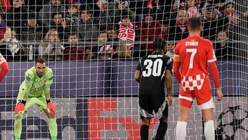 Girona's Spanish goalkeeper #25 Pau Lopez stands as Arsenal's English striker #30 Raheem Sterling prepares to shoot from the penalty spot during the UEFA Champions League, league phase football match between Girona FC and Arsenal FC at the Montilivi stadium in Girona on January 29, 2025. (Photo by Josep LAGO / AFP)