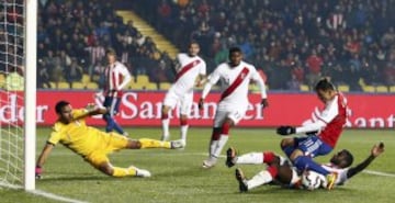 Paraguay's Edgar Benitez is tackled by Peru's Christian Ramos near the Peru net during their Copa America 2015 third-place soccer match at Estadio Municipal Alcaldesa Ester Roa Rebolledo in Concepcion, Chile, July 3, 2015. REUTERS/Mariana Bazo