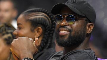 Chicago Bulls' Dwyane Wade, right, watches with actress Gabrielle Union during the first half of a WNBA basketball game between the Los Angeles Sparks and the Atlanta Dream, Friday, Sept. 1, 2017, in Los Angeles. (AP Photo/Mark J. Terrill)