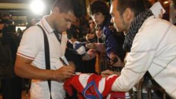 <b>BUEN RECIBIMIENTO. </b>Agüero le firma una camiseta rojiblanca a un aficionado en la llegada del Atlético a Castellón.