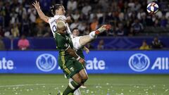 Los Angeles Galaxy forward Zlatan Ibrahimovic, top, takes a shot on goal as Portland Timbers defender Bill Tuiloma defends during the second half of an MLS soccer match Sunday, March 31, 2019, in Carson, Calif. (AP Photo/Marcio Jose Sanchez)