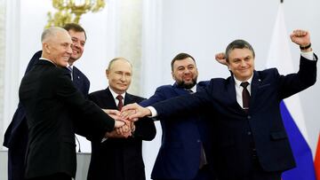 Russian President Vladimir Putin and Denis Pushilin, Leonid Pasechnik, Vladimir Saldo, Yevgeny Balitsky, who are the Russian-installed leaders in Ukraine's Donetsk, Luhansk, Kherson and Zaporizhzhia regions, attend a ceremony to declare the annexation of the Russian-controlled territories of four Ukraine's Donetsk, Luhansk, Kherson and Zaporizhzhia regions, after holding what Russian authorities called referendums in the occupied areas of Ukraine that were condemned by Kyiv and governments worldwide, in the Georgievsky Hall of the Great Kremlin Palace in Moscow, Russia, September 30, 2022. Sputnik/Dmitry Astakhov/Pool via REUTERS ATTENTION EDITORS - THIS IMAGE WAS PROVIDED BY A THIRD PARTY.     TPX IMAGES OF THE DAY