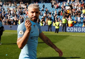 Manchester City's Sergio Aguero poses with his medal as he celebrates winning the Premier League