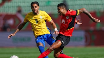 Gabon's forward #09 Pierre-Emerick Aubameyang and 15 Mozambique's defender #15 Reinildo Mandava vie during the Africa Cup of Nations (CAN) Group F football match between Gabon and Mozambique at Grand Stadium in Agadir on December 28, 2025. (Photo by FRANCK FIFE / AFP)
