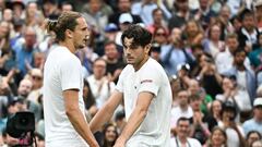 Winner US player Taylor Fritz (R) speaks with Germany's Alexander Zverev at the end of their men's singles tennis match on the eighth day of the 2024 Wimbledon Championships at The All England Lawn Tennis and Croquet Club in Wimbledon, southwest London, on July 8, 2024. (Photo by Ben Stansall / AFP) / RESTRICTED TO EDITORIAL USE