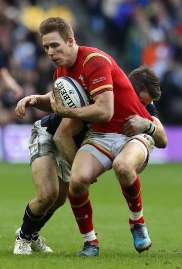 Liam Williams of Wales is held during the RBS Six Nations match against Scotland.