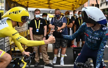 El ciclista esloveno del equipo UAE Team Emirates, Tadej Pogacar choca la mano con el ciclista danés del equipo Visma - Lease a Bike, Jonas Vingegaard, antes de tomar la salida hoy. 