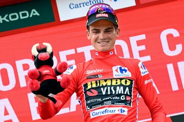 Sepp Kuss, del equipo Jumbo-Visma y líder de la clasificación general, en el podio con el maillot rojo.