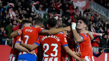 Girona's Ukrainian forward #08 Viktor Tsygankov celebrates with teammates after scoring his team's first goal during the Spanish league football match between Girona FC and Athletic Club Bilbao at the Montilivi stadium in Girona on November 27, 2023. (Photo by Josep LAGO / AFP)