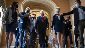 Senate Majority Leader Mitch McConnell is swarmed by reporters as he leaves the Senate floor and walks to his office at the U.S. Capitol.