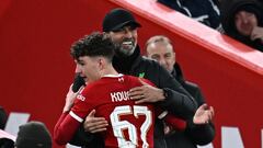 Liverpool's German manager Jurgen Klopp (R) congratulates Liverpool's English striker #67 Lewis Koumas (L) as he leaves the game, substituted during the English FA Cup fifth round football match between Liverpool and Southampton at Anfield stadium, in Liverpool, north west England, on February 28, 2024. (Photo by Paul ELLIS / AFP) / RESTRICTED TO EDITORIAL USE. No use with unauthorized audio, video, data, fixture lists, club/league logos or 'live' services. Online in-match use limited to 120 images. An additional 40 images may be used in extra time. No video emulation. Social media in-match use limited to 120 images. An additional 40 images may be used in extra time. No use in betting publications, games or single club/league/player publications. / 