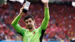 Belgium's goalkeeper Thibaut Courtois holds up a trophy as he celebrates his 100th match with the Belgian national team Red Devils prior to the UEFA Euro 2024 group F qualification football match between Belgium and Austria at the King Baudouin Stadium in Brussels, on June 17, 2023. (Photo by Kenzo TRIBOUILLARD / AFP)