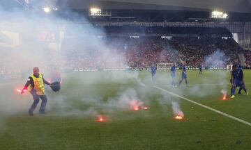 Flares are thrown onto the pitch during the Euro 2016 Group D soccer match between the Czech Republic and Croatia