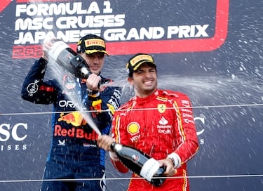 Formula One F1 - Japanese Grand Prix - Suzuka Circuit, Suzuka, Japan - April 7, 2024 Red Bull's Max Verstappen celebrates on the podium after winning the Japanese Grand Prix along with third placed Ferrari's Carlos Sainz Jr. REUTERS/Androniki Christodoulou