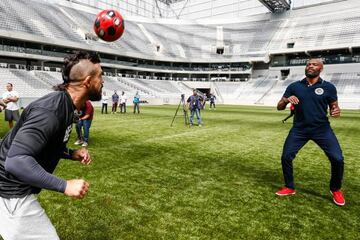 Vitor Belfort y Anderson Silva, estrellas de la UFC, juegan con un balón en la Arena da Baixada.