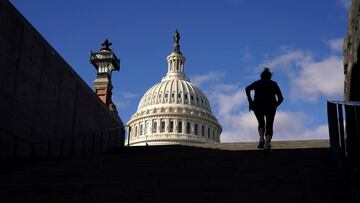 A woman exercises on steps at the U.S. Capitol where Congress passed a massive COVID-19 aid and government funding package overnight, in Washington, U.S., December 22, 2020.  REUTERS/Kevin Lamarque