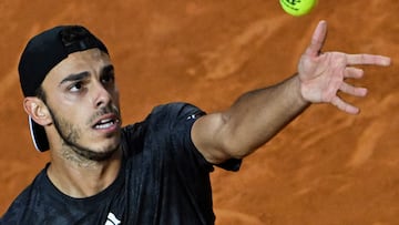 Argentina's Francisco Cerundolo serves to Norway's Casper Ruud during their quarterfinals match of the Men's ATP Rome Open tennis tournament at Foro Italico in Rome on May 17, 2023. cerund (Photo by Tiziana FABI / AFP)