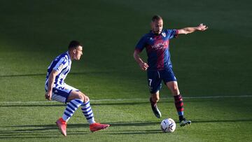 HUESCA, SPAIN - MAY 01: David Ferreiro of SD Huesca is put under pressure by Ander Barrenetxea of Real Sociedad  during the La Liga Santander match between SD Huesca and Real Sociedad at Estadio El Alcoraz on May 01, 2021 in Huesca, Spain. Sporting stadiu