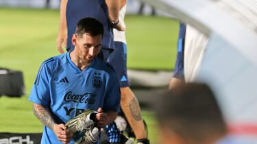 Argentina's forward Lionel Messi reacts walks with his boots during a training camp in Abu Dhabi ahead of the Qatar 2022 FIFA football World Cup, at the Nahyan Stadium, on November 14, 2022. (Photo by Karim SAHIB / AFP)