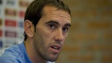 Uruguay's defender and captain Diego Godin speaks during a press conference at Complejo Celeste sport centre, in Canelones, on October 11, 2015. Uruguay will face Colombia next October 13, for a FIFA World Cup Russia 2018 qualifier football match. AFP PHOTO / PABLO PORCIUNCULA