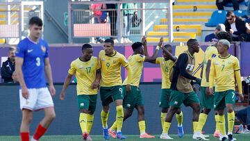 South Africa's forward #9 Jody Ahshene (2nd-L) celebrates with teammates after scoring his team's first goal past France's goalkeeper #01 Lisandru Olmeta during the 2025 FIFA U20 World Cup football match between France and South Africa at El Teniente Stadium in Rancagua, Chile on September 29, 2025. (Photo by Raul BRAVO / AFP)