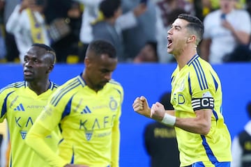 Nassr's Portuguese forward #7 Cristiano Ronaldo celebrates scoring his team's first goal during the Saudi Pro League football match between Al-Nassr and Damac at Al-Awwal Park in Riyadh on November 29, 2024. (Photo by Fayez NURELDINE / AFP)