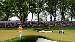 May 21, 2023; Rochester, New York, USA; Viktor Hovland (left) watches as Brooks Koepka putts on the 13th green during the final round of the PGA Championship golf tournament at Oak Hill Country Club. Mandatory Credit: Aaron Doster-USA TODAY Sports