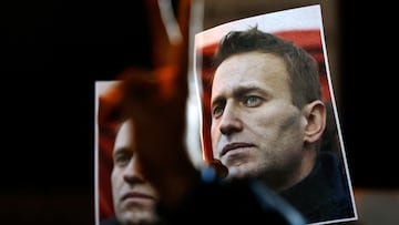 A person gestures in front of portraits of Russian opposition leader Alexei Navalny as people attend a protest and vigil held in front of the Russian embassy following the death of Navalny, in Kappara, Malta, February 19, 2024. REUTERS/Darrin Zammit Lupi