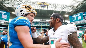 MIAMI GARDENS, FLORIDA - OCTOBER 12: Tua Tagovailoa #1 of the Miami Dolphins and Justin Herbert #10 of the Los Angeles Chargers embrace after the game at Hard Rock Stadium on October 12, 2025 in Miami Gardens, Florida. Carmen Mandato/Getty Images/AFP (Photo by Carmen Mandato / GETTY IMAGES NORTH AMERICA / Getty Images via AFP)