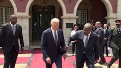 Biden helped by Angola President Lourenco to climb steps to podium