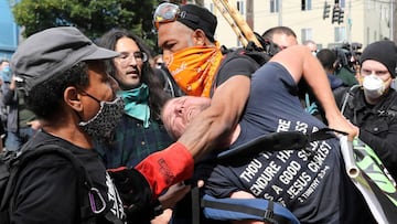 Protesters remove a man from the protest because he was bothering other protesters at the self-proclaimed Capitol Hill Autonomous Zone (CHAZ) during a protest against racial inequality and call for defunding of Seattle police, in Seattle, Washington, U.S.