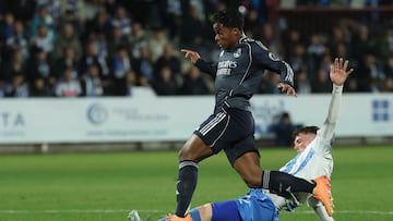 Real Madrid's Brazilian forward #16 Endrick fights for the ball with Talavera's Spanish defender #2 David Cuenca (down) during the Spanish Copa del Rey (King's Cup) round of 32 second leg football match between Talavera CF and Real Madrid CF at El Prado Municipal Stadium in Talavera de la Reina on December 17, 2025. (Photo by Thomas COEX / AFP)